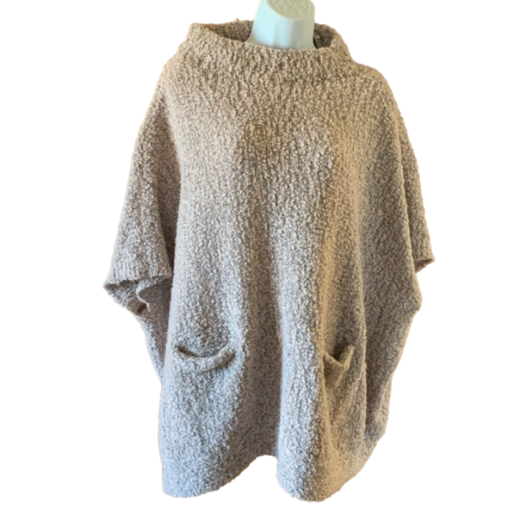Medium knit oversized mauve sweater with front pockets on rack